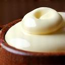 Rich, creamy shea butter in a rustic wooden bowl.